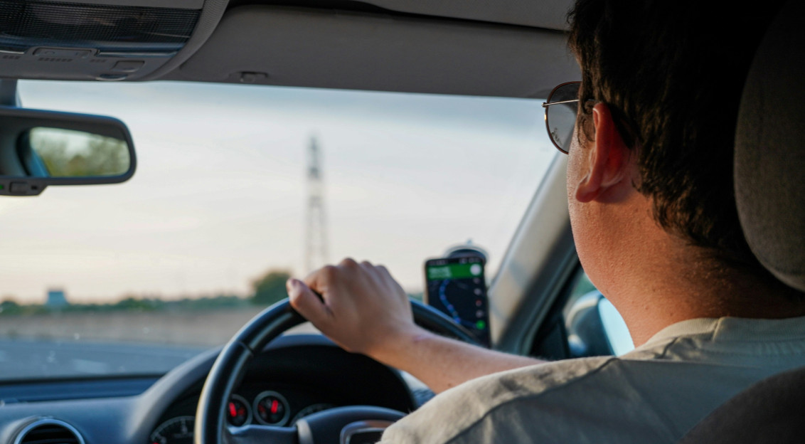 Photo by Unsplash An illustrative photo of a man driving a car.