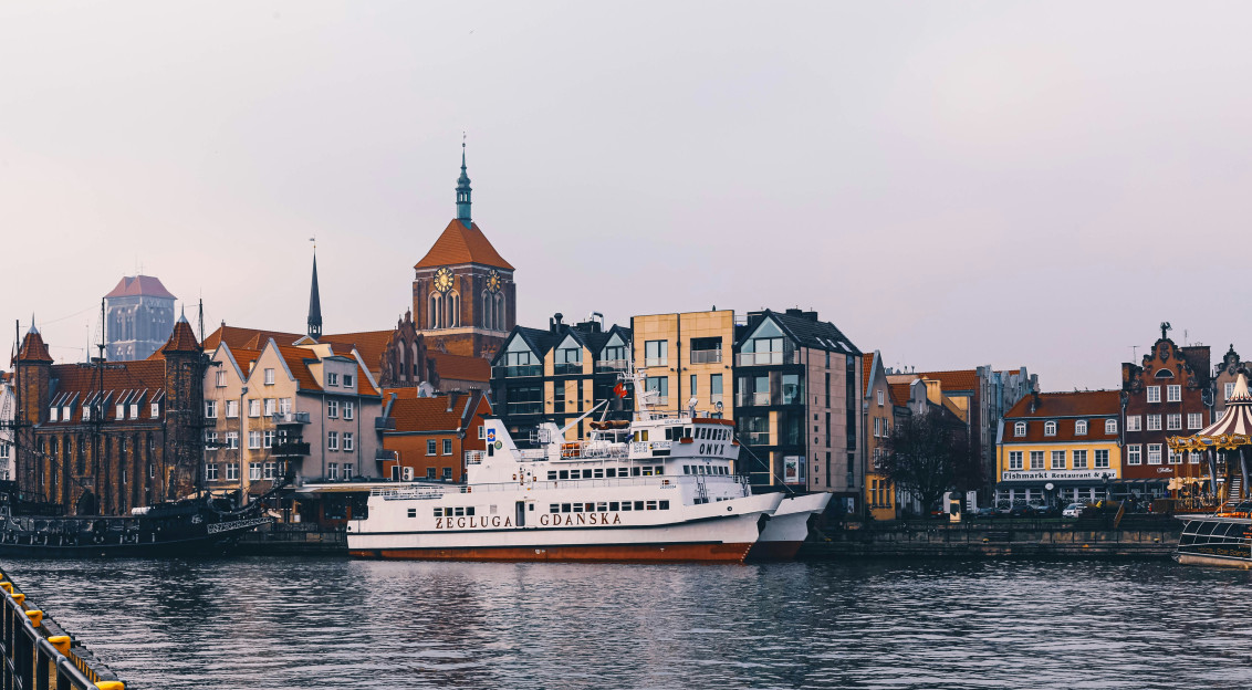 An illustrative photo of a boat in a body of water near a city.