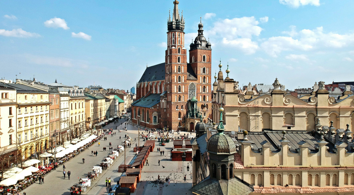 An illustrative photo of a view of a city square with a tower in the background.