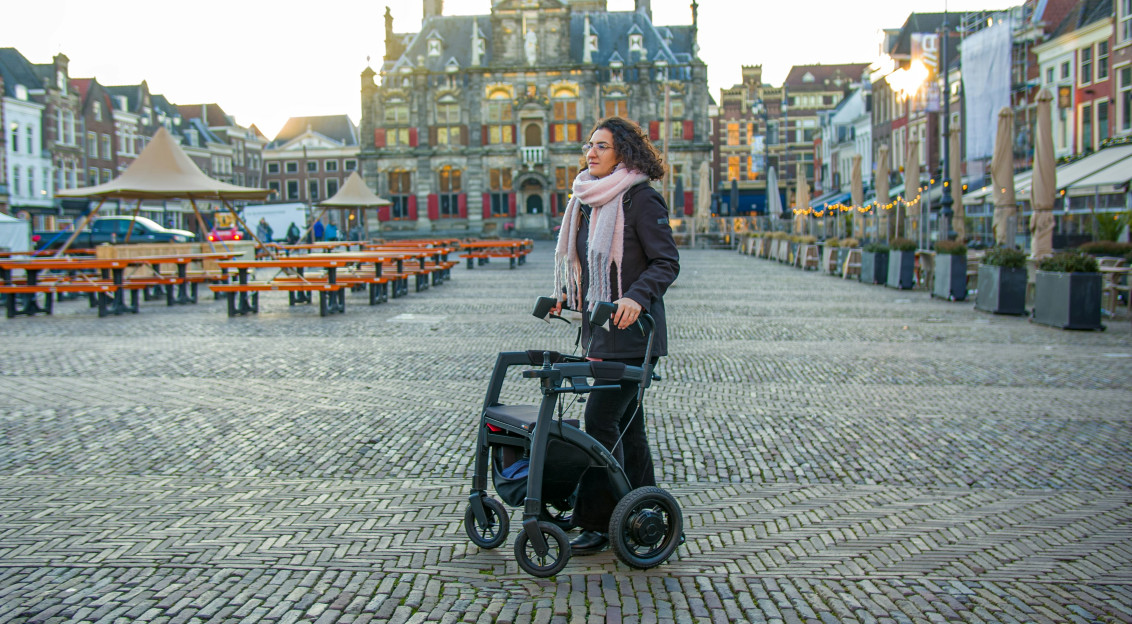 An illustrative photo of a woman with disability on a city square.