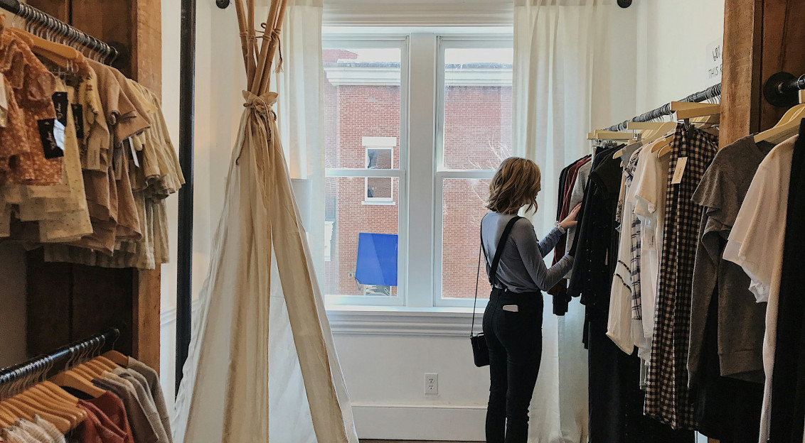 Woman standing selecting clothes. 