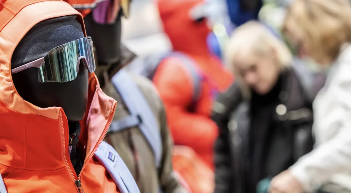 Dummy wearing orange jacket and sporty sunglasses 