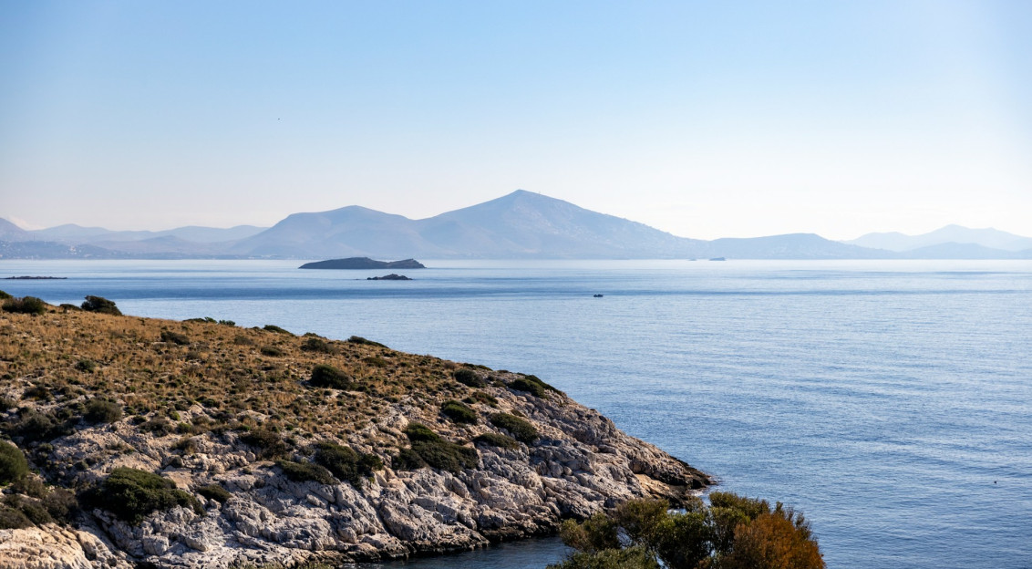 a-view-of-a-body-of-water-with-mountains-in-the-background