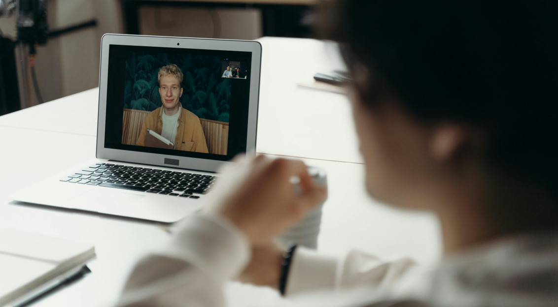 Man talking to another man online.